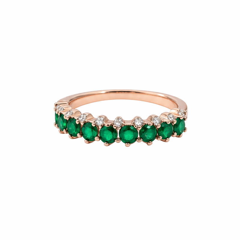 Elegant rose gold ring with vibrant green stones and sparkling accents.