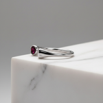 Elegant open-ended silver ring featuring twin heart-shaped ruby stones.