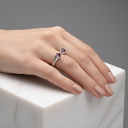 Elegant open-ended silver ring featuring twin heart-shaped ruby stones.