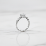Elegant solitaire ring with delicate twisted band.