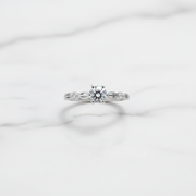 Elegant solitaire ring with delicate twisted band.