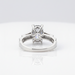 Elegant solitaire ring with sparkling side accents.