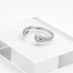 Elegant open-end silver ring with dual sparkling stones.