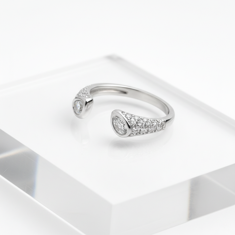Elegant open-end silver ring with dual sparkling stones.