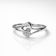Elegant silver heart ring with sparkling stones, designed to symbolize love and timeless charm